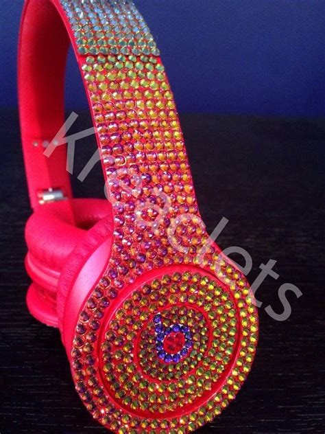 The Headphones Are Decorated With Colorful Jewels And Sparkles On Top Of Each Other