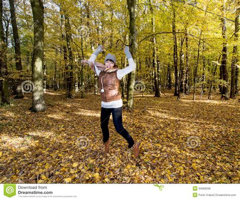 Joyful Caucasian Woman Jumping In The Autumn Leaves Stock Photo Image