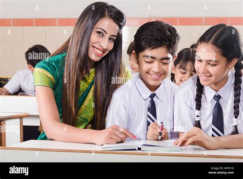 Indian School Students And Teacher Book Studying In Classroom Stock