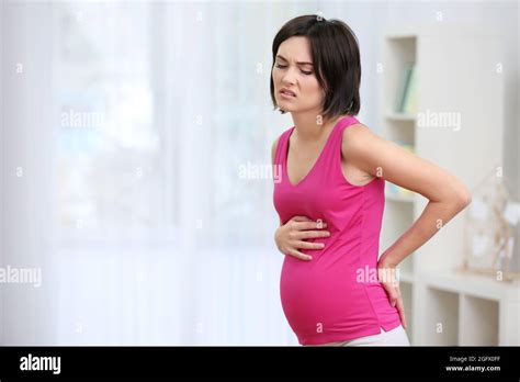 Young Pregnant Woman Suffering From Backache At Home Stock Photo Alamy