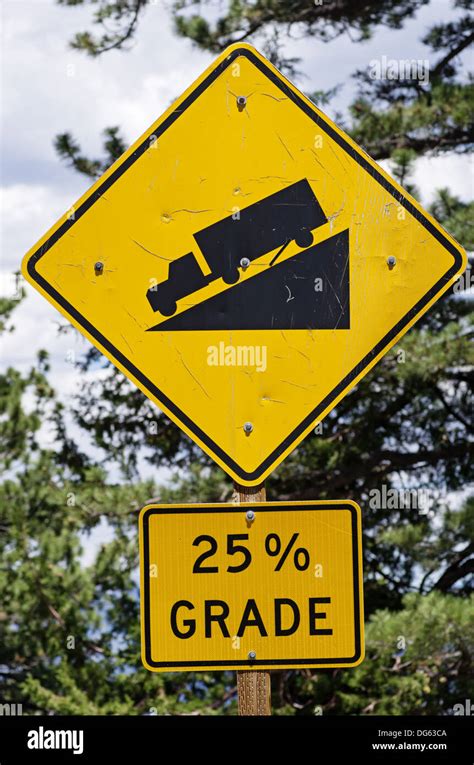 Warning Steep Road Sign With 25 Percent Grade And Truck On Hill Stock