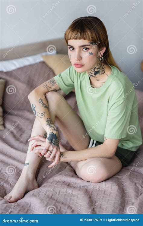 Young Tattooed Woman Sitting On Bed Stock Image Image Of Relax