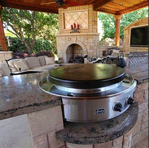 Outdoor kitchen with round grill top built right into the ...
