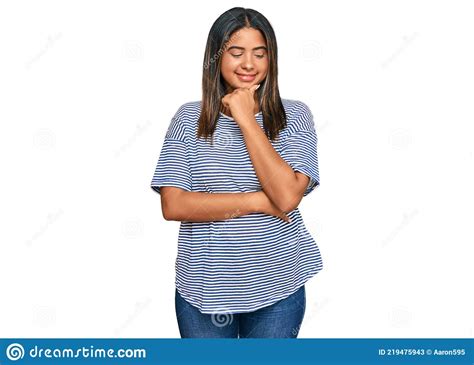 Young Latin Girl Wearing Casual Clothes With Hand On Chin Thinking