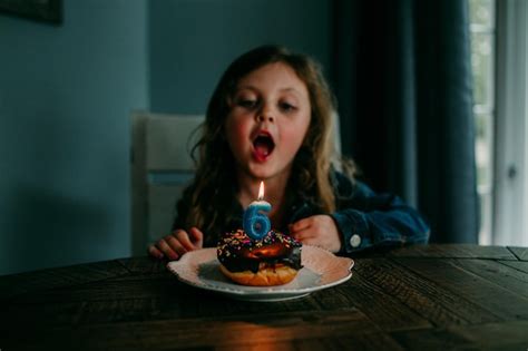 Premium Photo Cute Girl Blowing Candle On Birthday Cake