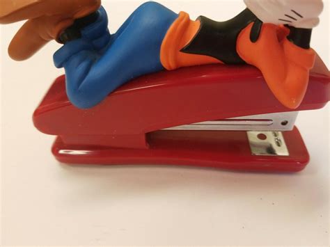 Goofy Laying Down On Top Of Red Stapler Walt Disney Mickey Mouse And
