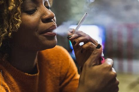 brazilian woman smoking a cigarette at home del colaborador de stocksy mauro grigollo stocksy