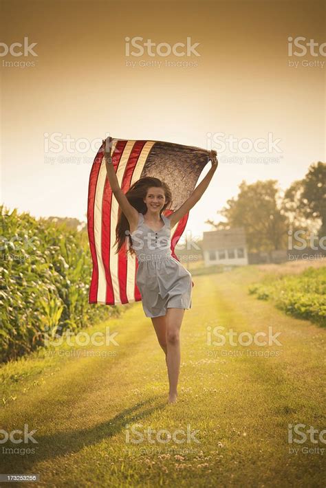 Patriotic Teen Farm Girl Running Through Field Waving Us Flag Stock