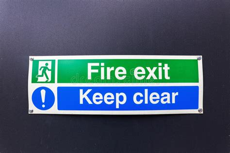 Fire Exit Sign On Black Wall Stock Photo Image Of Safety Icon 75722444