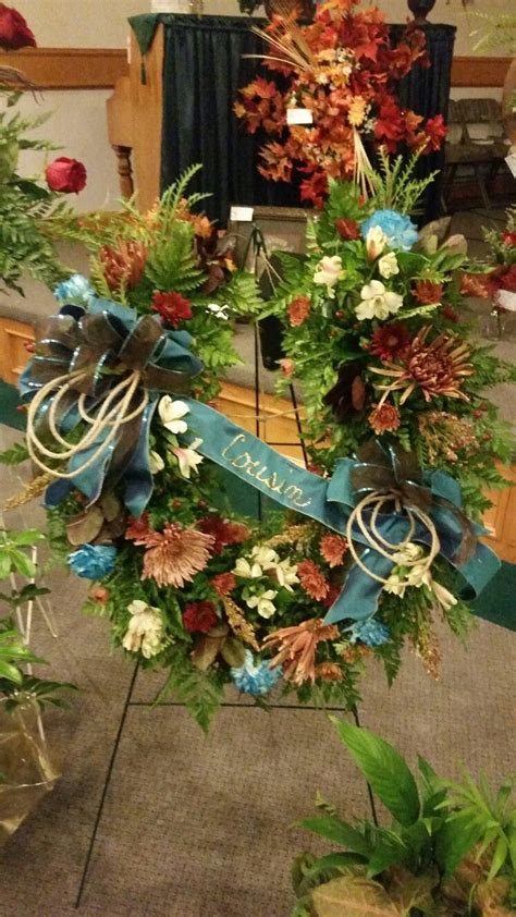 Dark or muted coloured clothing. Fresh horseshoe for funeral | Funeral floral arrangements ...