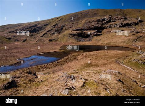 Dale Head Tarn A Prominent Feature On The Slopes Of The Mountain In
