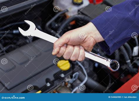 Car Mechanic Is Holding A Wrench Ready To Check The Engine And