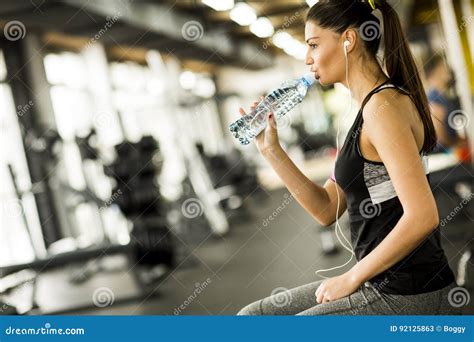 Attractive Sporty Young Woman Drinking Water In The Gym Stock Image