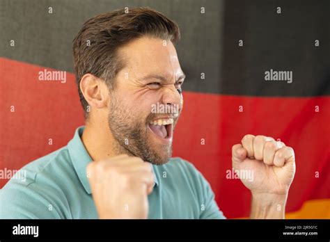 Image Of Happy Caucasian Man With Flags Of Germany On Face Over Flag Of