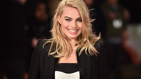 Margot Robbie Is Wearing White Top And Black Coat With A Smiley Face 4K