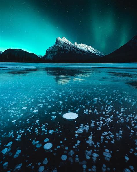 Ice Bubbles Under The Northern Lights In Banff Alberta Rmostbeautiful