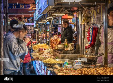 Night Market Vendors Selling Street Food In The Muslim Quarter In Xian