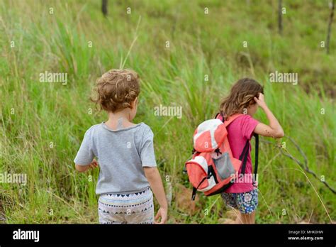Two Children Walk Along A Path Through A Forest Mount Stuart Hiking