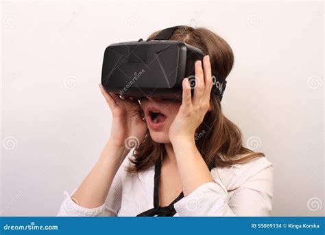 an impressed dizzy flabbergasted man wearing oculus rift vr virtual reality headset editorial