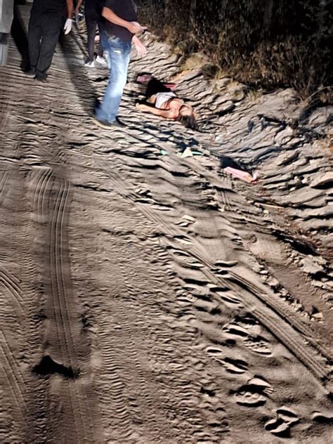 Found The Dead Body Of A Young Woman Shot In The Head On A Sandy Road