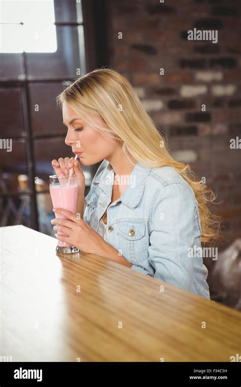 Pretty Blonde Drinking Smoothie Through Straw Stock Photo Alamy