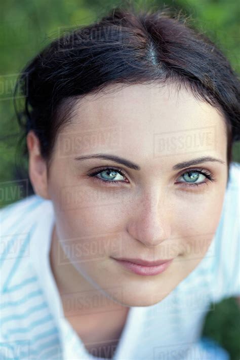 A Beautiful Young Woman Looking Serenely Into The Camera Stock Photo