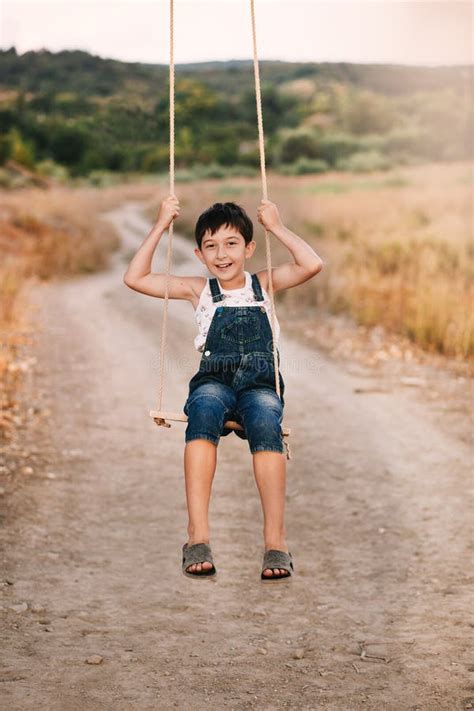 Happy Young Boy Playing On Swing In A Park Stock Image Image Of Male