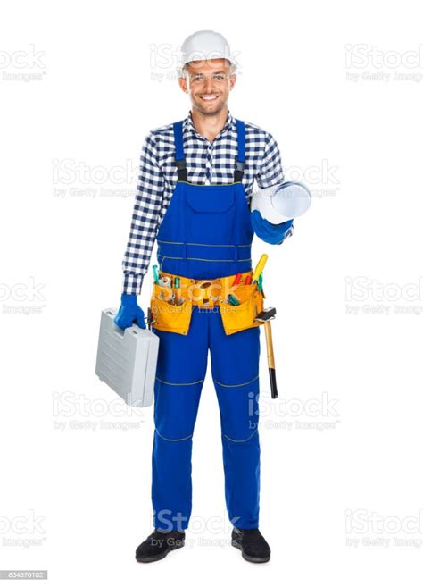 Full Length Portrait Of Happy Construction Worker In Uniform With