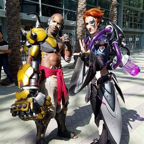 Two Cosplays Dressed In Costumes Posing For The Camera