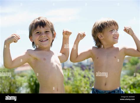 Boys Flexing Muscles Stock Photo Alamy
