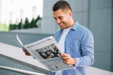 Handsome Man Reading Newspaper On Street Free Photo
