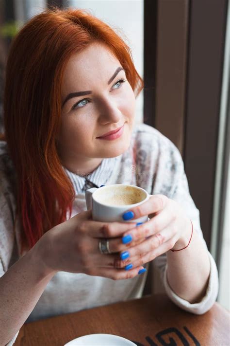 Young Attractive Woman Enjoying A Cup Of Coffee In Cafe Stock Photo