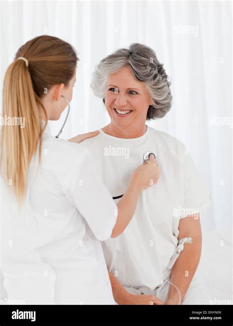Nurse Taking The Heartbeat Of Her Patient Stock Photo Alamy