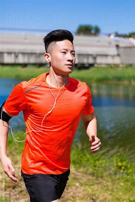 Young Chinese Man Running In The City By Stocksy Contributor Giorgio