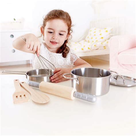14 piece stainless steel set (a whisk, ladle, spatula, slotted spoon, spaghetti server), pans with lid and handles, 12 cutting vegetables toys, and 1 piece chef apron & potholders. Chef's Cooking Set | E3137 | Hape Toys