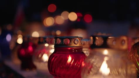 Grave Candles Lights Glowing On Cemetery At Night On All Saints Day