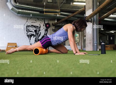 Sportswoman Dans La Salle De Gym étirant Et Massant Ses Muscles Avec Un Concept De Style De Vie