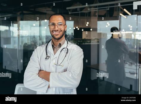 Portrait Of A Young Handsome Male Hispanic Doctor Standing In The