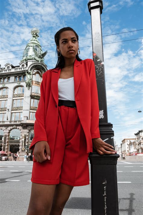 Woman In Red Long Sleeve Dress Standing Near The Building · Free Stock