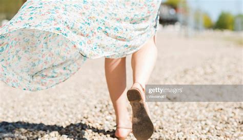Woman Walking On Shingle Beach Photo Getty Images