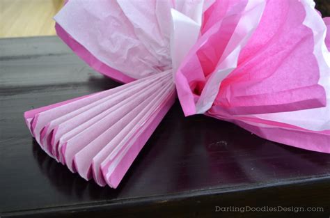 Lay your tissue paper out with the sheets neatly placed on top of each other. Tissue Pom-Pom Tutorial - Darling Doodles