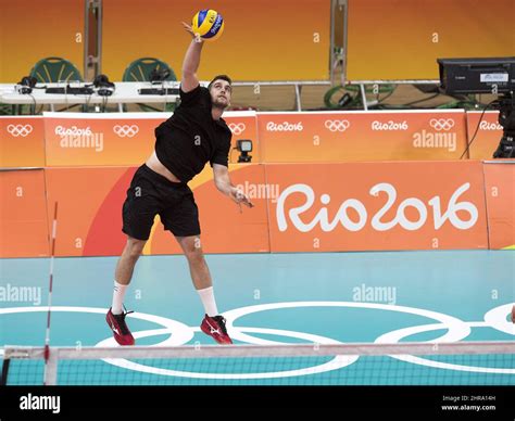 canadian olympic men s volleyball team member tj sanders serves during team practice at the 2016