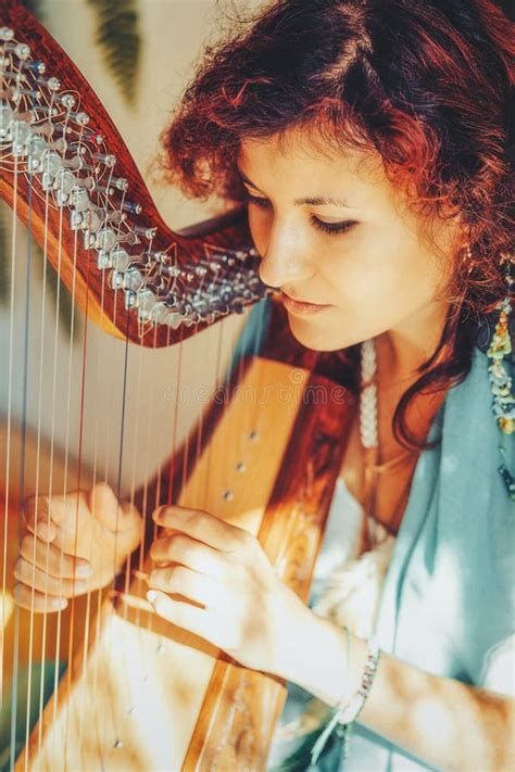 Woman With A Harp Beautiful Girl Harpist Playing Her Instrument Stock