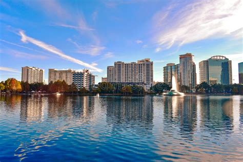 Lake Eola Park And Colorful Business Buildings On Beautiful Sunset