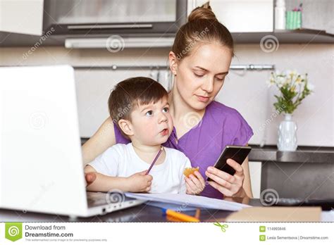 Photo Of Busy Working Mother Tries To Solve Financial Problems Waits