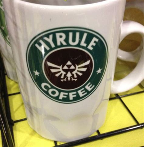 A Coffee Mug With The Legend Of Zelda Logo On It Sitting On A Table