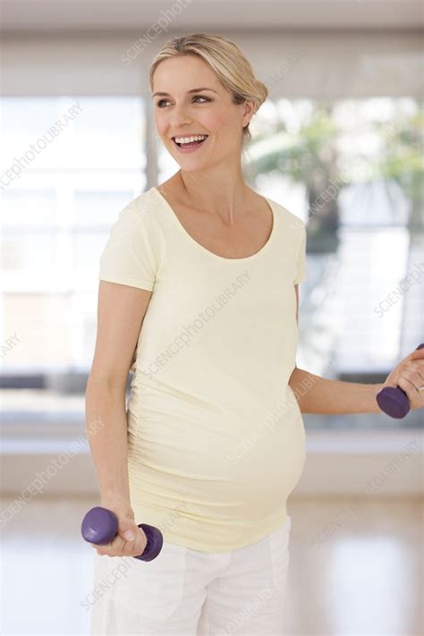 Pregnant Woman Lifting Weights Stock Image F005 5982 Science Photo Library