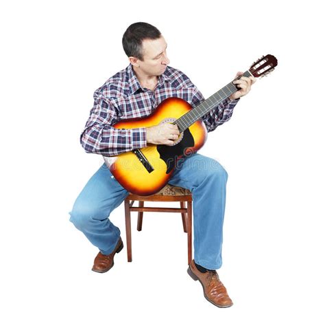 Adult Man Plays A Guitar Sitting On An Chair Stock Photography Image