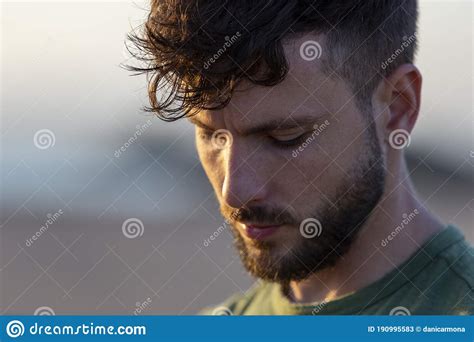 Close Up Portrait Of A Young Handsome Man During The Sunset With His