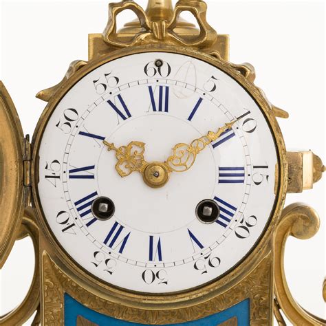 A Mid 19th Century French Gilt Brass Mantel Clock With A Pair Of